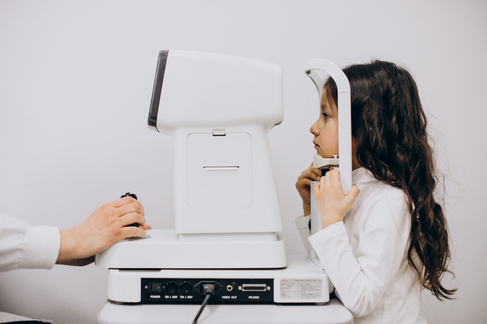 little girl checking up her sight at ophthalmology center